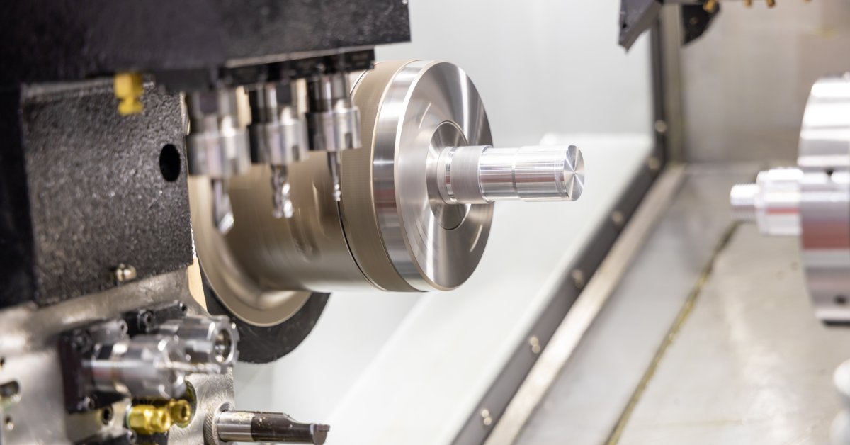 A multi-tool CNC machine up close. The machine has various drill bits on vertical and horizontal axes.